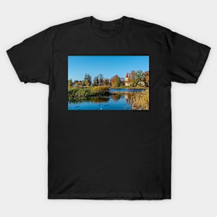 Church standing on the calm lake shore in sunny day T-Shirt